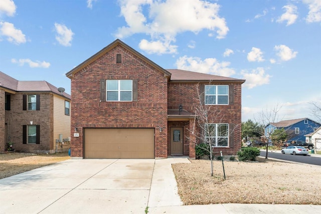 traditional home featuring a garage, brick siding, and driveway