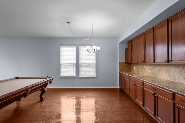 interior space featuring a chandelier, dark wood-style flooring, billiards, and baseboards