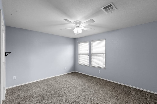 carpeted spare room featuring ceiling fan, a textured ceiling, visible vents, and baseboards