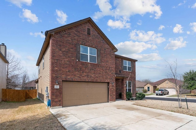 traditional-style house featuring brick siding, driveway, an attached garage, and fence