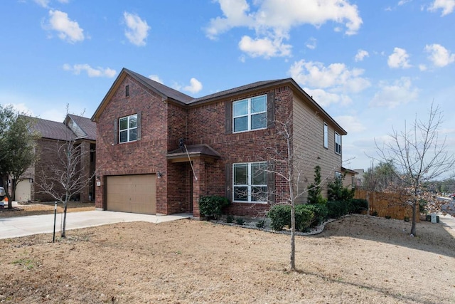 traditional home with a garage, brick siding, and driveway