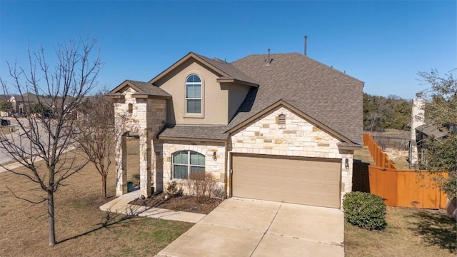 view of front of house with a garage, concrete driveway, stone siding, fence, and stucco siding