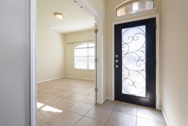 entryway featuring light tile patterned flooring and baseboards