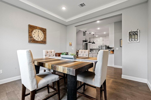 dining area with dark wood-type flooring, recessed lighting, visible vents, and baseboards