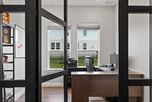 office area featuring visible vents, wood finished floors, and french doors