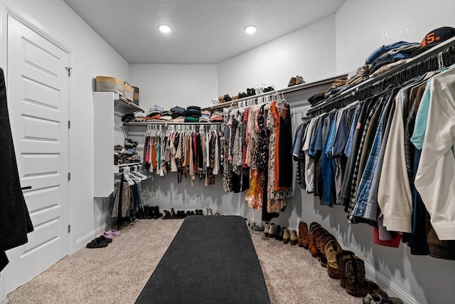 walk in closet featuring carpet floors