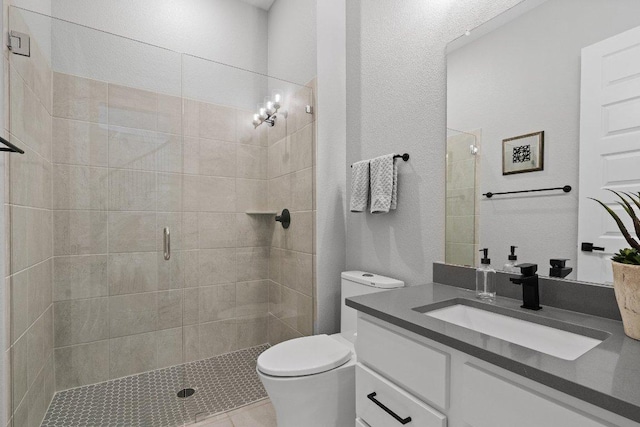 full bathroom with toilet, a shower stall, and vanity