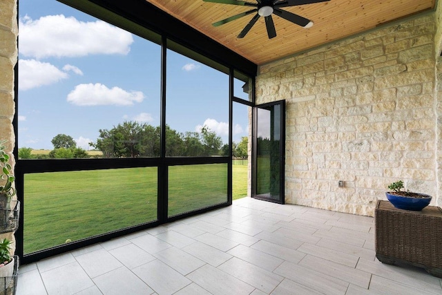 unfurnished sunroom featuring ceiling fan and wooden ceiling