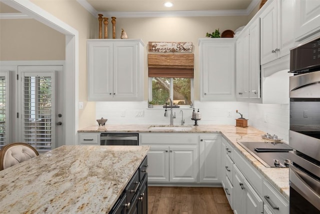 kitchen featuring ornamental molding, white cabinets, dishwasher, and a sink