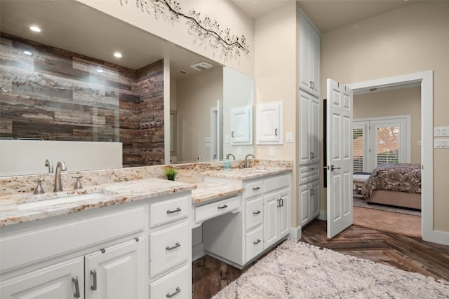 full bathroom with recessed lighting, visible vents, vanity, parquet floors, and ensuite bath