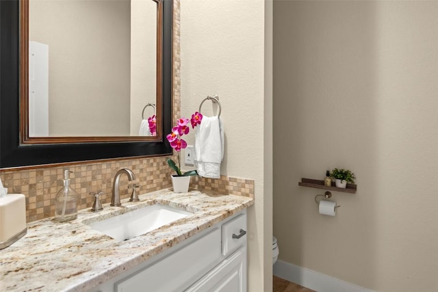 2216 Garden Ct, San Marcos, TX 78666 - bathroom with toilet, vanity, and decorative backsplash