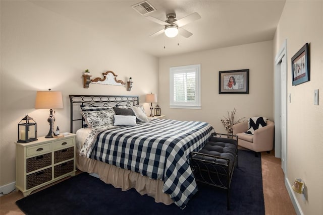 carpeted bedroom featuring a ceiling fan, visible vents, and baseboards