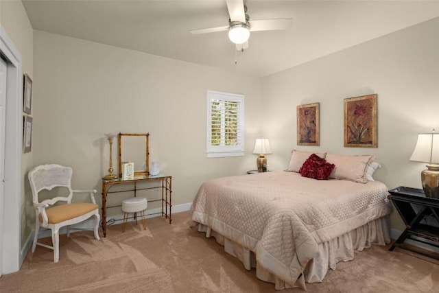 carpeted bedroom with a closet, baseboards, and a ceiling fan