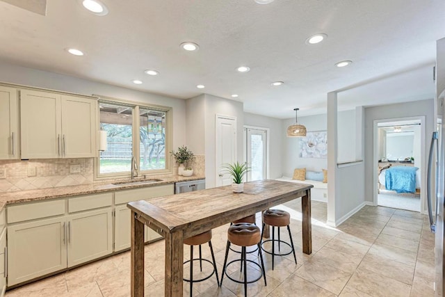 4113 Rimrock Dr, Lago Vista, TX 78645 - kitchen with dishwasher, plenty of natural light, a sink, and decorative backsplash