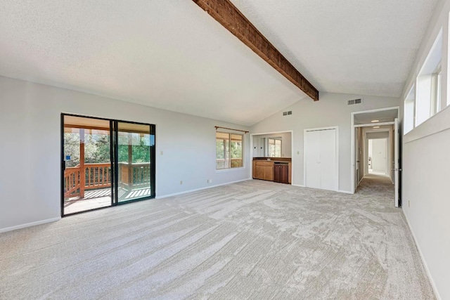 4113 Rimrock Dr, Lago Vista, TX 78645 - interior space featuring light carpet, baseboards, visible vents, lofted ceiling with beams, and a textured ceiling