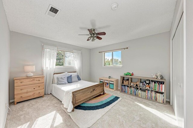 4113 Rimrock Dr, Lago Vista, TX 78645 - carpeted bedroom featuring a closet, visible vents, ceiling fan, and a textured ceiling