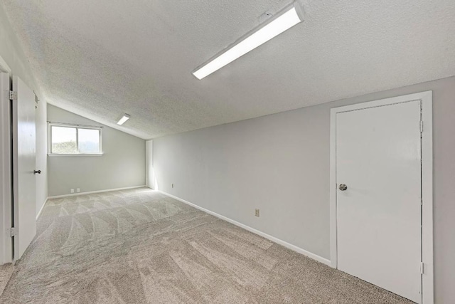 4113 Rimrock Dr, Lago Vista, TX 78645 - additional living space featuring a textured ceiling, vaulted ceiling, carpet flooring, and baseboards