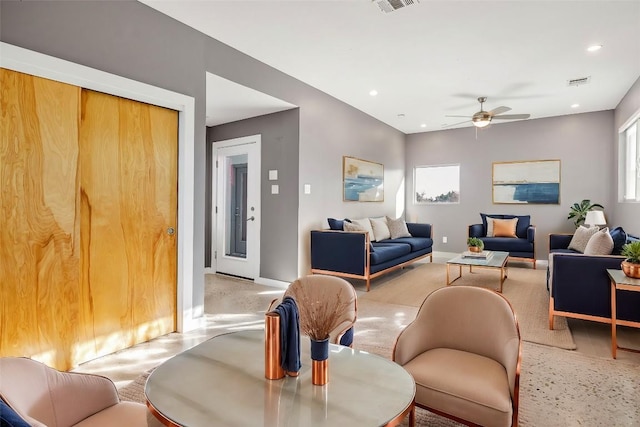 living room featuring baseboards, visible vents, and recessed lighting