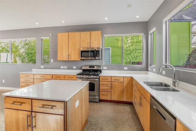 kitchen featuring light countertops, stainless steel appliances, a sink, and recessed lighting