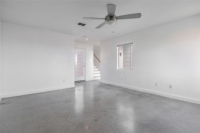 spare room featuring stairs, visible vents, a ceiling fan, baseboards, and speckled floor