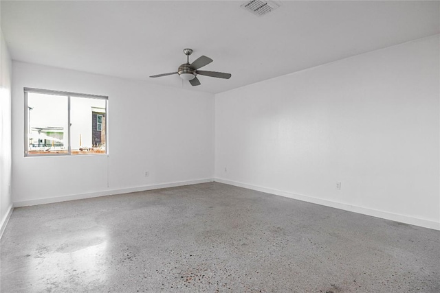 empty room with ceiling fan, visible vents, baseboards, and speckled floor