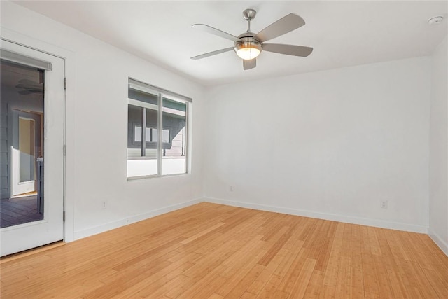 unfurnished room with light wood-style floors, baseboards, and a ceiling fan