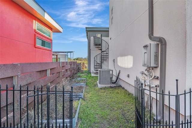 exterior space with fence, stairway, and central air condition unit