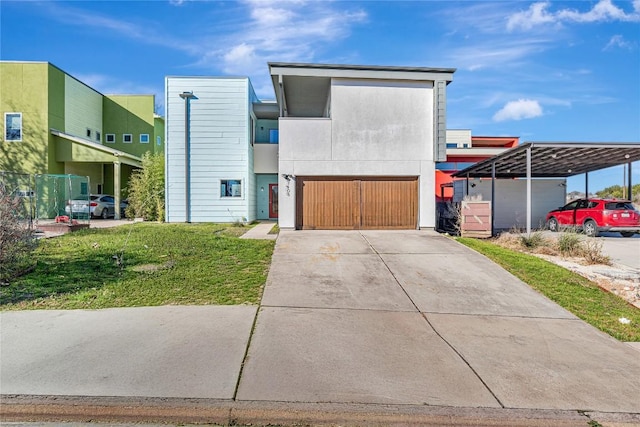 contemporary home featuring a garage, driveway, and stucco siding