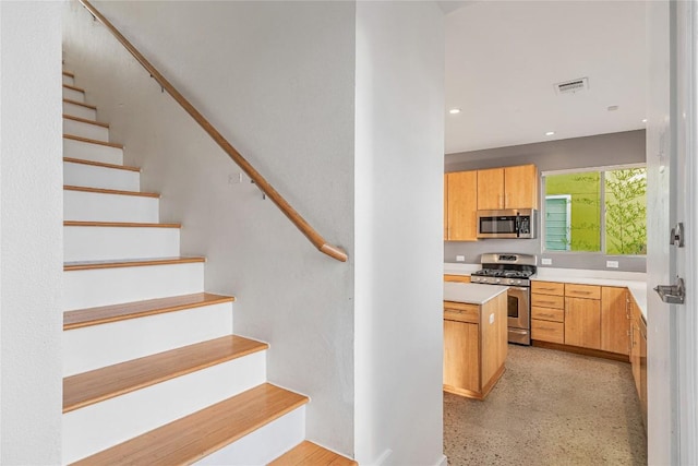 kitchen with visible vents, stainless steel appliances, light countertops, light speckled floor, and recessed lighting