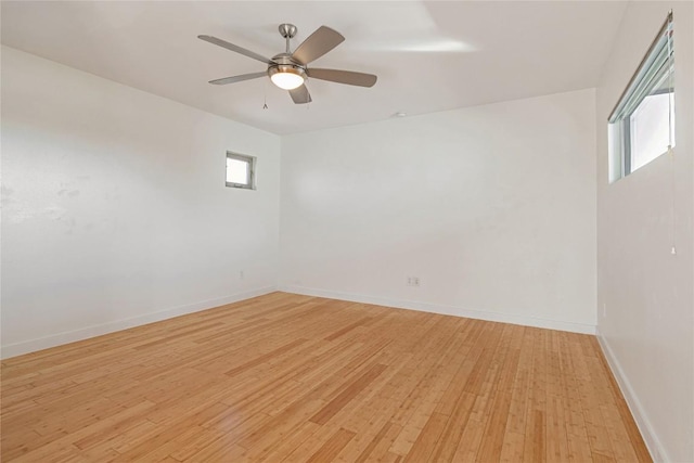 empty room with light wood-style flooring, baseboards, and a ceiling fan