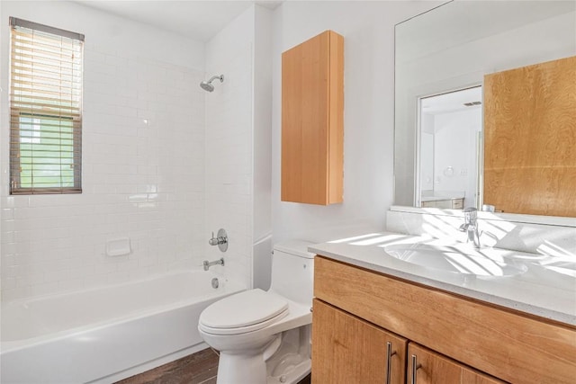 bathroom featuring toilet, shower / bath combination, wood finished floors, and vanity