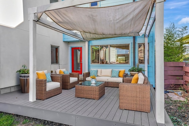 deck featuring outdoor lounge area and fence