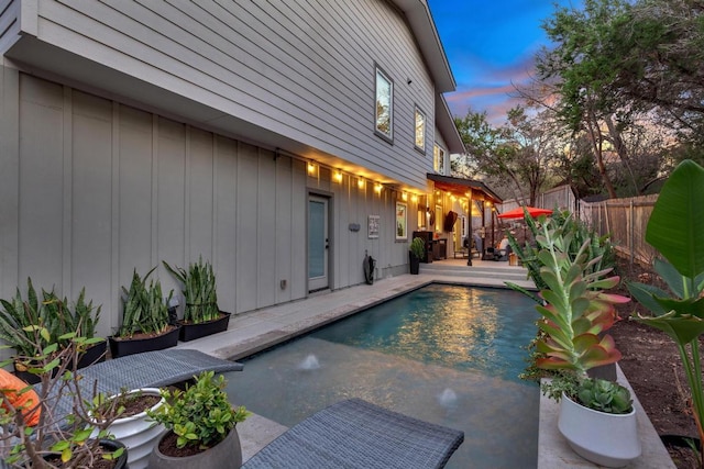 view of pool with a patio area, a fenced in pool, and fence