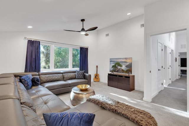 carpeted living area with recessed lighting, visible vents, and vaulted ceiling