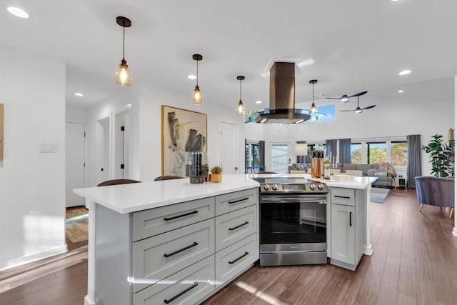 632 Galston Dr, Spicewood, TX 78669 - kitchen with electric range, island exhaust hood, open floor plan, light countertops, and dark wood-type flooring