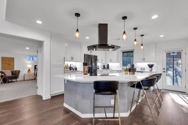632 Galston Dr, Spicewood, TX 78669 - kitchen with black appliances, exhaust hood, white cabinetry, light countertops, and a large island