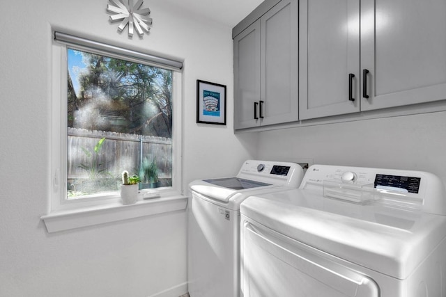 laundry room featuring washer and clothes dryer and cabinet space