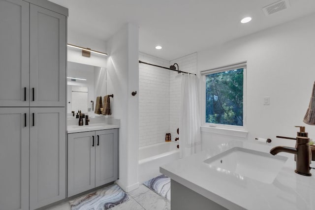 full bath with visible vents, shower / tub combo with curtain, marble finish floor, recessed lighting, and vanity