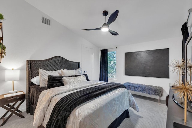 carpeted bedroom featuring visible vents, ceiling fan, and vaulted ceiling