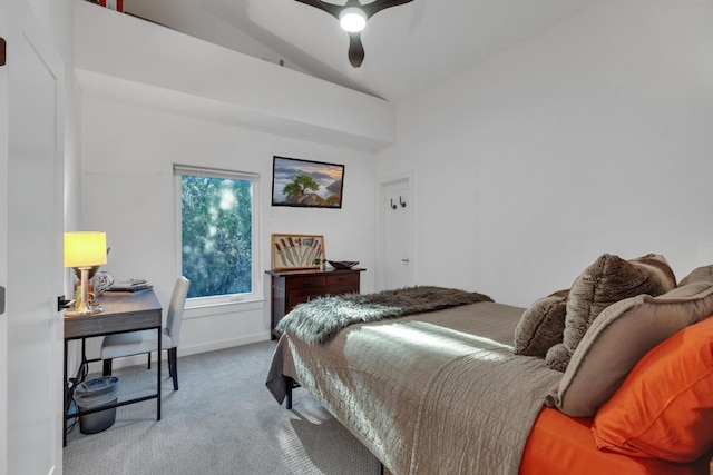 carpeted bedroom featuring baseboards, lofted ceiling, and ceiling fan