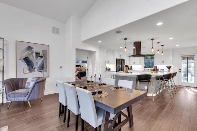632 Galston Dr, Spicewood, TX 78669 - dining room featuring wood finished floors, a towering ceiling, and recessed lighting