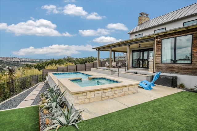 view of swimming pool featuring a fenced in pool, a patio, a ceiling fan, an in ground hot tub, and a fenced backyard