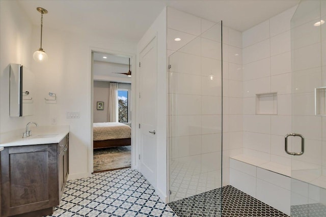 ensuite bathroom featuring a stall shower, connected bathroom, vanity, and tile patterned floors