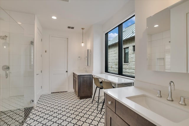 full bathroom with recessed lighting, two vanities, a sink, visible vents, and a stall shower