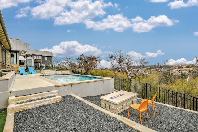 view of pool with a fenced in pool, a patio area, fence, and a fire pit