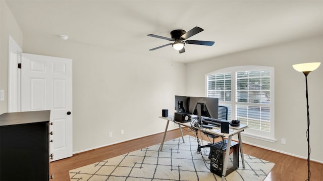 office with ceiling fan, baseboards, and wood finished floors