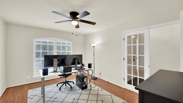 home office featuring wood finished floors, a ceiling fan, and baseboards