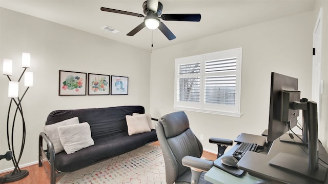 home office with baseboards, ceiling fan, visible vents, and wood finished floors