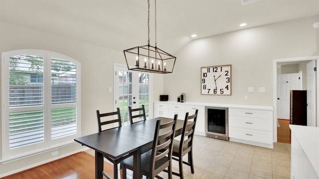 dining space with a healthy amount of sunlight, recessed lighting, wine cooler, and french doors