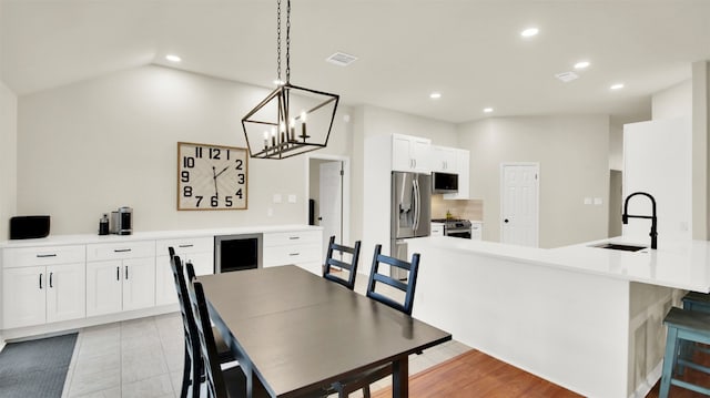 dining room with lofted ceiling, visible vents, and recessed lighting